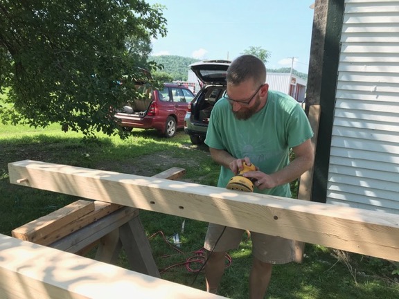 MRVPD Executive Director, Joshua Schwartz, sands hemlock posts for the Scrag Mountain Town Forest Kiosk (July 2, 2018). Source: Bob Cook